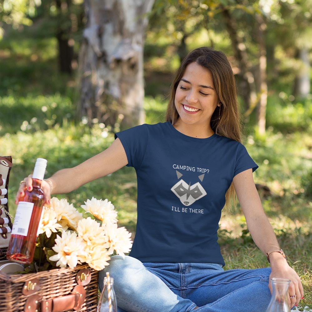 woman at picnic wearing navy camping raccoon shirt